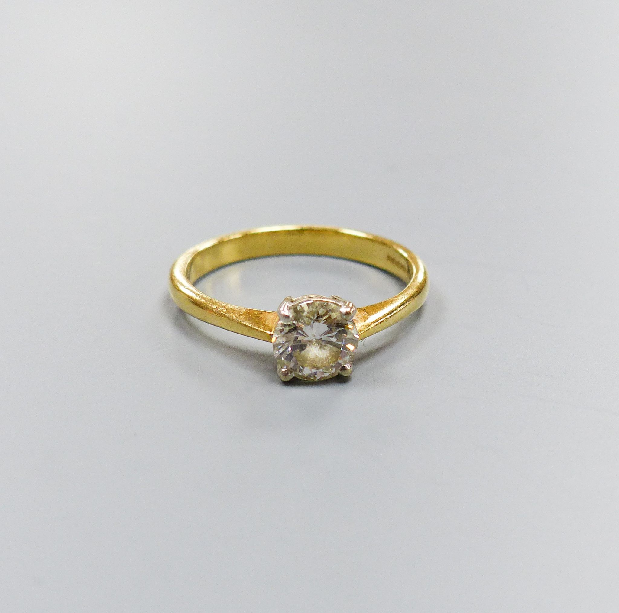 A modern 18ct gold and solitaire diamond ring, size O, gross 3.2 grams